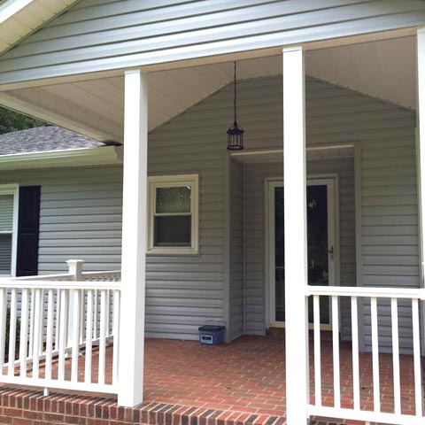 Siding by the Best - freshly painted trim on windows facing front porch of home