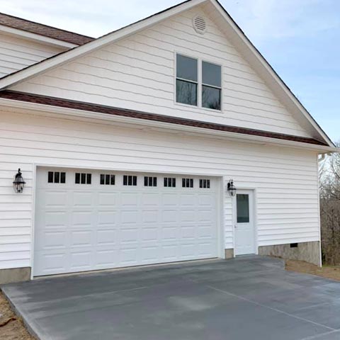 Siding by the Best - white house with freshly painted garage door